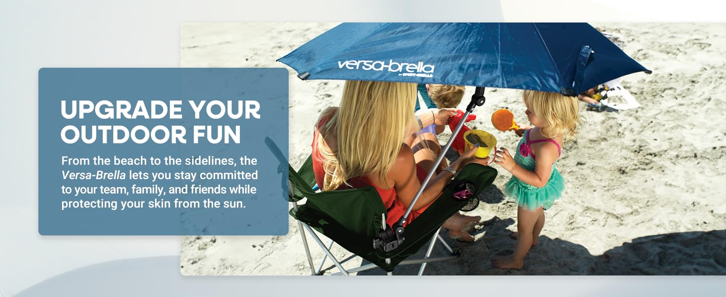 family playing in the sand under an angled versa-brella
